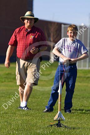 Father and son launching a model rocket for science education in Boise, Idaho.