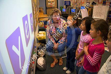 Kindergarten students use an interactive whiteboard in the classroom of a public school in Boise, Idaho, USA. MR