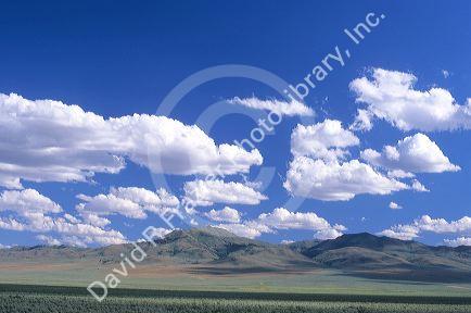Cumulus clouds over Malheur County, Oregon high desert mountains.