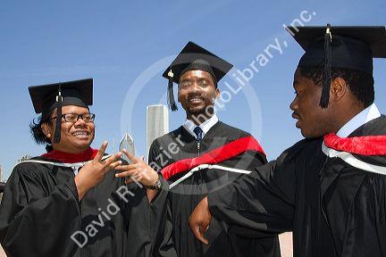 Multi ethnic college graduates celebrate the occasion in Grant Park, Chicago, Illinois, USA.