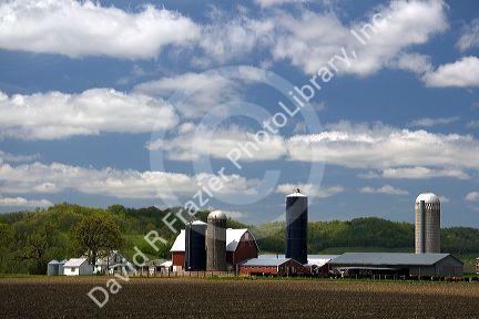 Red barn and grain silos on a farm in Manitowoc County, Wisconsin, USA.