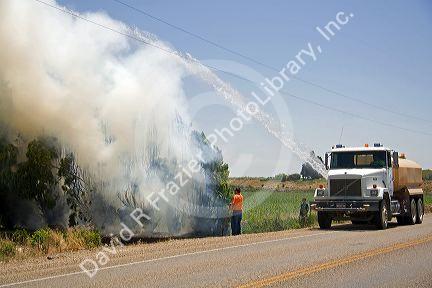 Water truck putting out a residential fire in Canyon County, Idaho, USA.