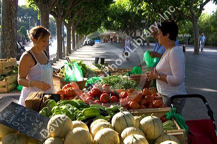 French people shopping at an outdoor produce market in Sanary sur Mer, Southern France.