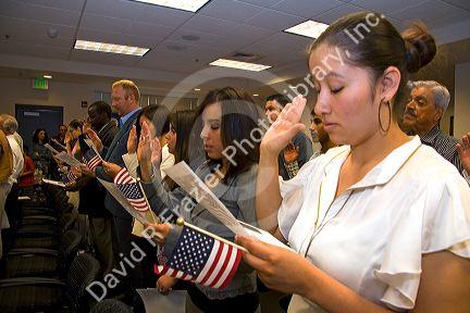 New United States citizens raise their right hand for citizenship oath ceremony in Idaho, USA.