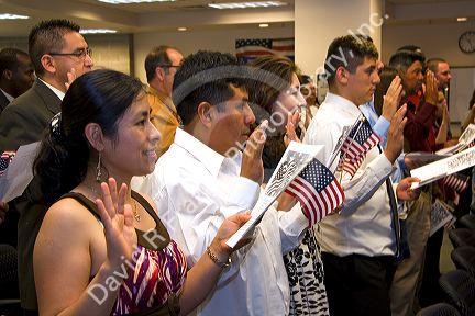 New United States citizens raise their right hand for citizenship oath ceremony in Idaho, USA.