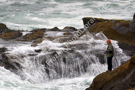 Fisherman at Boiler Bay on the Pacific Ocean near Depot Bay, Oregon, USA.