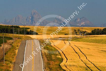Teton Range in the distance along Idaho Highway 32 near Ashton, Idaho, USA.