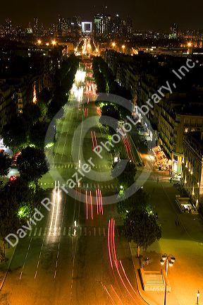 Night view of the Avenue des Champs-Elysees looking toward the Arche de la Defense located in Paris, France.