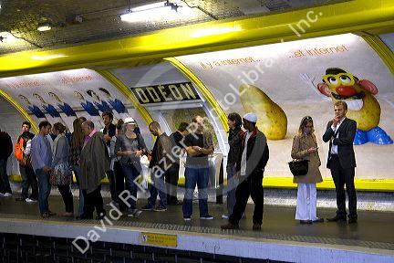 People wait underground on the platform of the Odeon Paris Metro station in Paris, France.