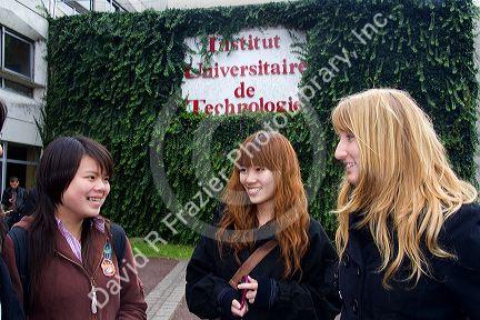 Female students socialize in front of the Paul Verlaine Univeristy technology building in Metz, France.