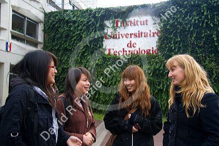 Female students socialize in front of the Paul Verlaine Univeristy technology building in Metz, France.