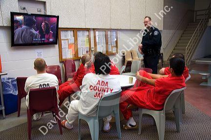 Inmates watch television in the recreational area of a county jail.
