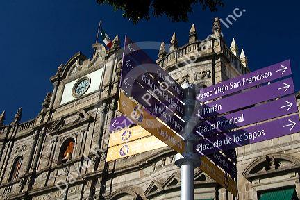 Spanish language street direction signs in front of the Palacio Municipal or City Hall in the city of Puebla, Puebla, Mexico.