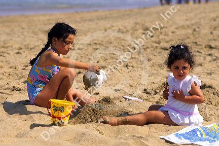 Children build sandcastles on the beach at Renaca, Chile.