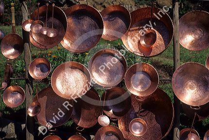 Copper cookware being sold along the roadside in Chile.