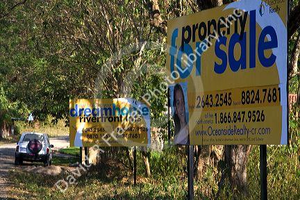Real estate signage along Highway 1 near Quebrada, Costa Rica.