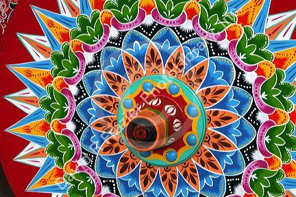 Carretas are elaborately painted oxcarts in the city of Sarchi Norte, Cosat Rica.  This view is a detail of a wheel.