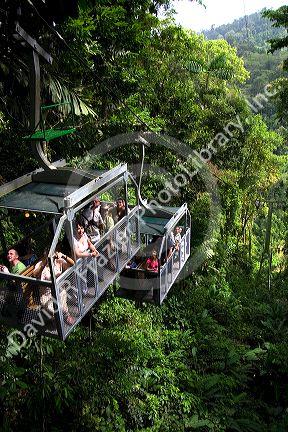 Tourists ride an aerial tram ride through the rainforest canopy of Veragua Rainforest Research and Adventure Park near Limon, Costa Rica.