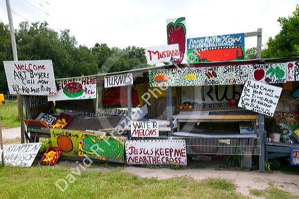 Colorful signage of a roadside produce stand along Highway 60 near Brandon, Florida, USA.