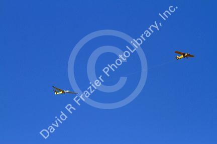 Sailplane being aerotowed behind a powered aircraft in the sky above the Air Force Academy in Colorado Springs, Colorado, USA.