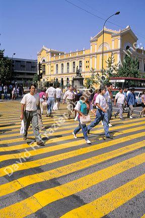 People using a crosswalk in front of the library in Santiago, Chile.