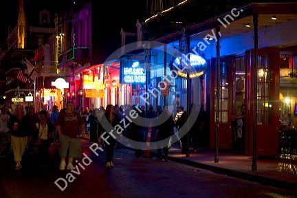 Neon signs of bars and restaurants along Bourbon Street in the French Quarter of New Orleans, Louisiana, USA.