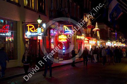 Neon signs of bars and restaurants along Bourbon Street in the French Quarter of New Orleans, Louisiana, USA.