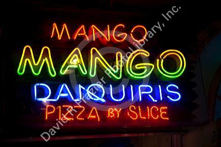 Neon sign advertising drinks and food in the French Quarter of New Orleans, Louisiana, USA.