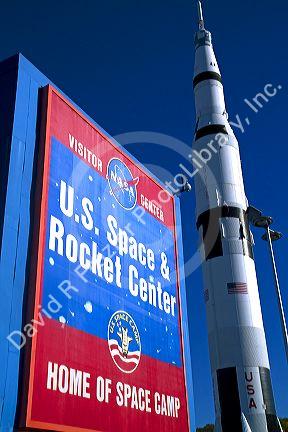 Saturn V mock-up stands next to the U.S. Space and Rocket Center sign located in Huntsville, Alabama, USA.