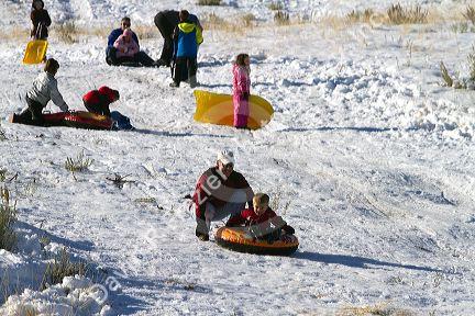 Sledding on a snowy hill near Boise, Idaho, USA.