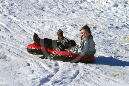 Sledding on a snowy hill near Boise, Idaho, USA.