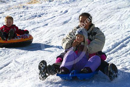 Sledding on a snowy hill near Boise, Idaho, USA.