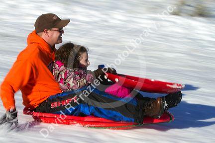 Sledding on a snowy hill near Boise, Idaho, USA.