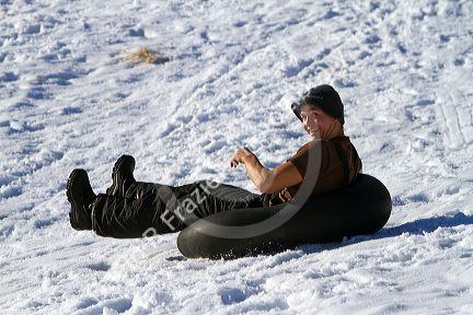 Sledding on a snowy hill near Boise, Idaho, USA.