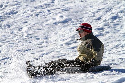Sledding on a snowy hill near Boise, Idaho, USA.