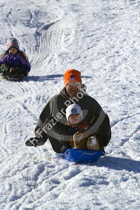 Sledding on a snowy hill near Boise, Idaho, USA.