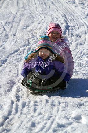Sledding on a snowy hill near Boise, Idaho, USA.