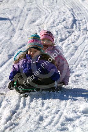 Sledding on a snowy hill near Boise, Idaho, USA.