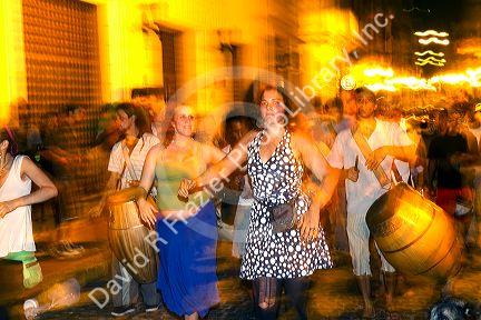 People parade and dance along Defensa street in the San Telmo barrio of Buenos Aires, Argentina.