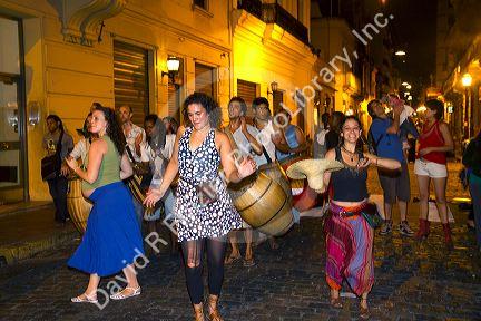 People parade and dance along Defensa street in the San Telmo barrio of Buenos Aires, Argentina.