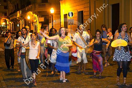 People parade and dance along Defensa street in the San Telmo barrio of Buenos Aires, Argentina.