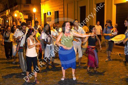 People parade and dance along Defensa street in the San Telmo barrio of Buenos Aires, Argentina.