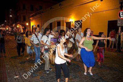 People parade and dance along Defensa street in the San Telmo barrio of Buenos Aires, Argentina.