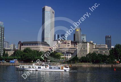 A boat travels on the Main River in Frankfurt, Germany.