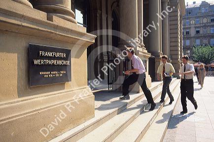 Businessmen walking into the Frankfurt stock exchange, Germany.