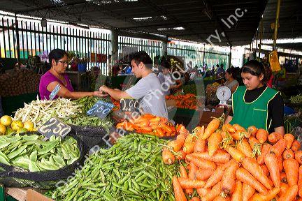 Vendor at a cooperative produce market in the Chorrillos district of Lima, Peru.