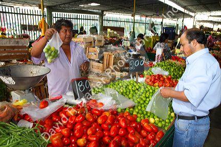 Vendor at a cooperative produce market in the Chorrillos district of Lima, Peru.
