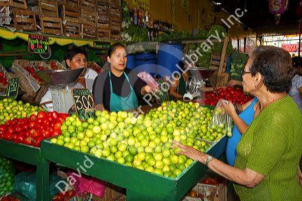 Vendor at a cooperative produce market in the Chorrillos district of Lima, Peru.