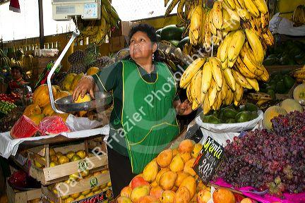 Vendor at a cooperative produce market in the Chorrillos district of Lima, Peru.