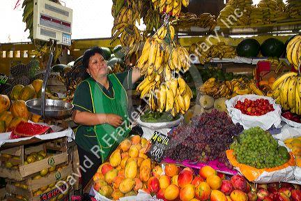 Vendor at a cooperative produce market in the Chorrillos district of Lima, Peru.